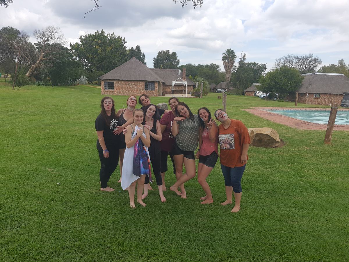 Group of friends on the lawn near the pool
